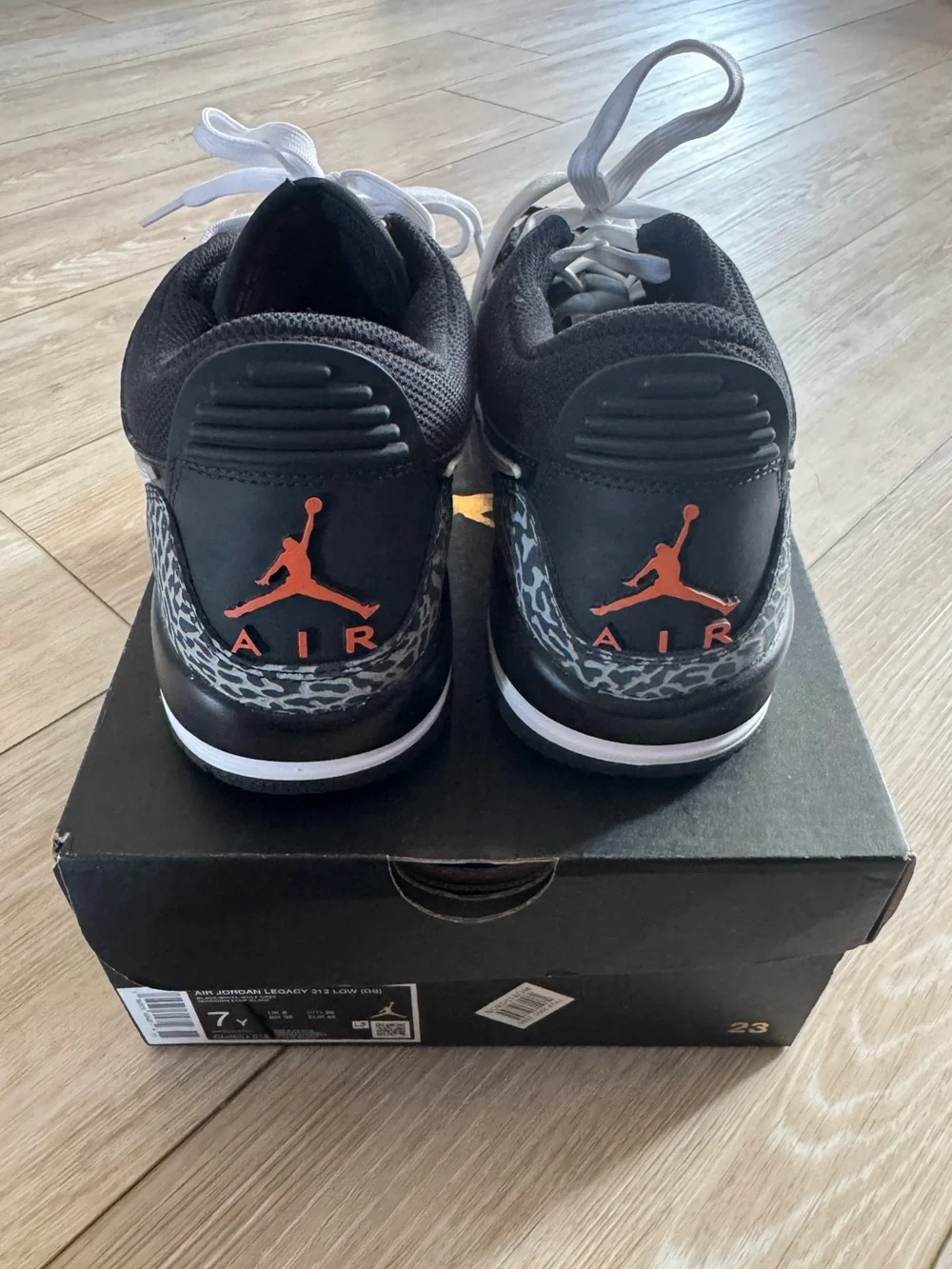 Nike Men’s Black and White Sneakers with Orange Logo Accent